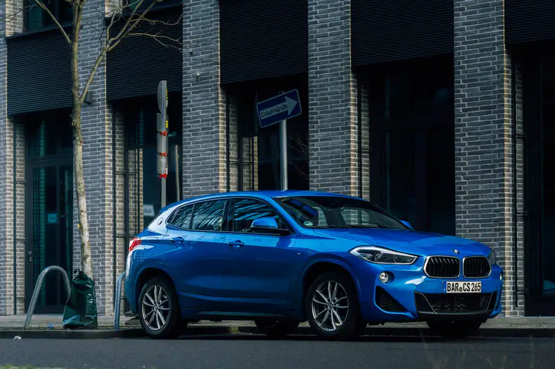 Plavi BMW X2 parkiran u gradu